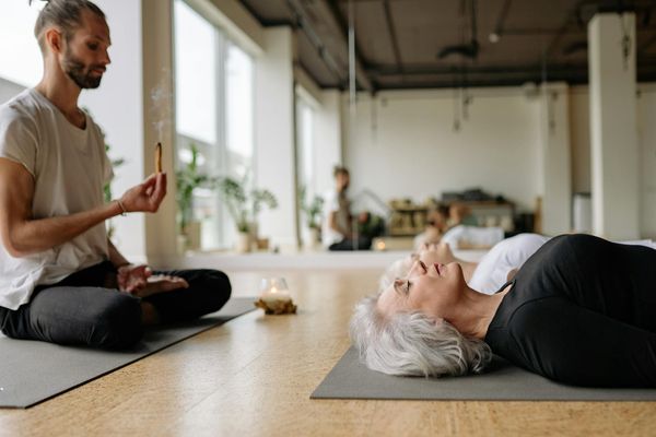 A serene studio space with yoga mats, ready for a group session.